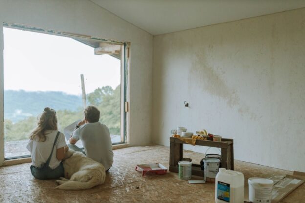 A couple planning a home renovation in a room being remodeled