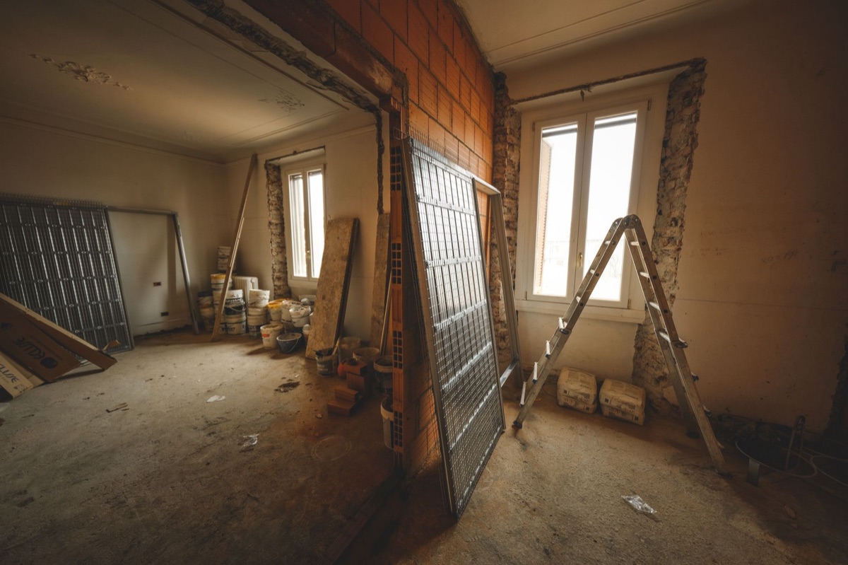 A room mid-renovation with ladder and construction materials